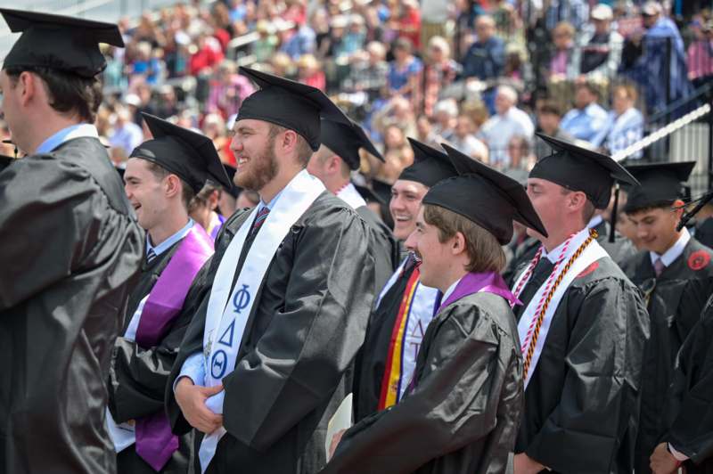 a group of people in graduation gowns and caps