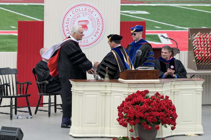 a man shaking hands with other men