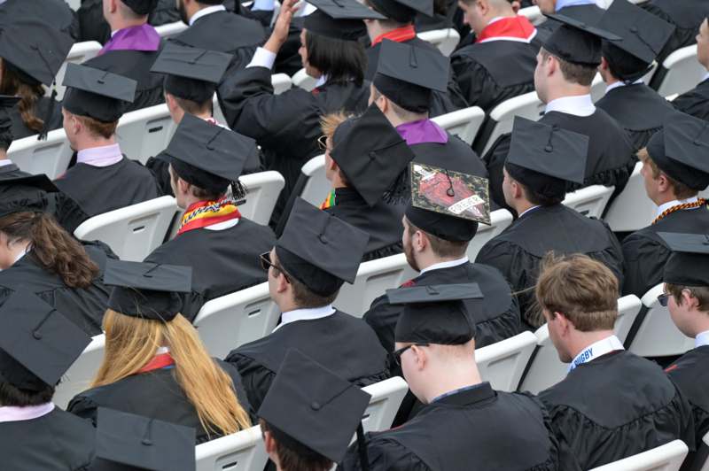 a group of people in graduation gowns and caps
