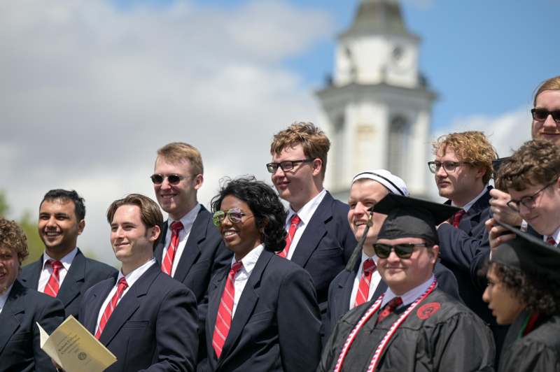 a group of people in suits and gowns