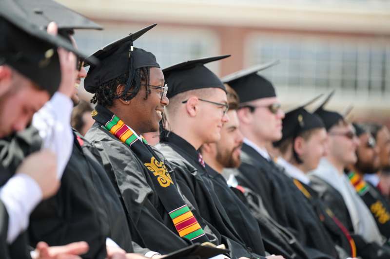 a group of people in graduation gowns and caps