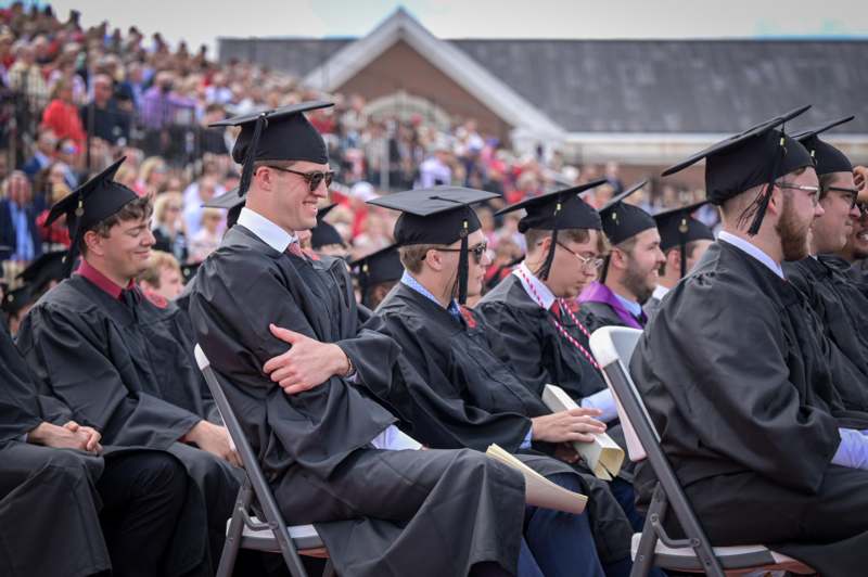 a group of people in graduation gowns and caps