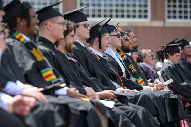 a group of people in graduation gowns and caps