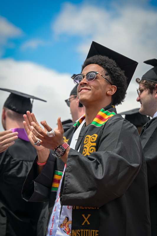 a group of people in graduation gowns and cap