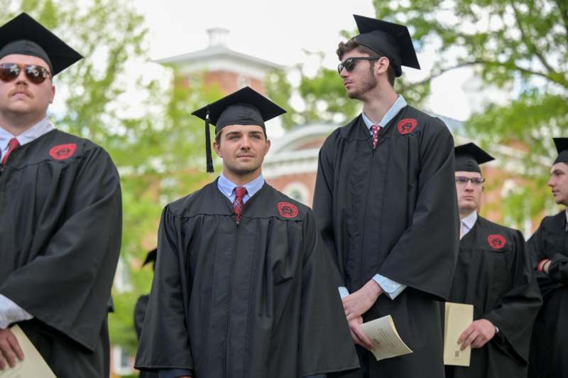 a group of men in graduation gowns