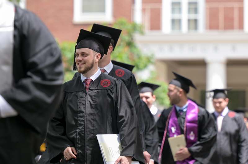 a group of people in graduation gowns and caps