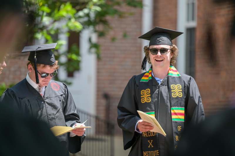 a group of people in graduation gowns and caps