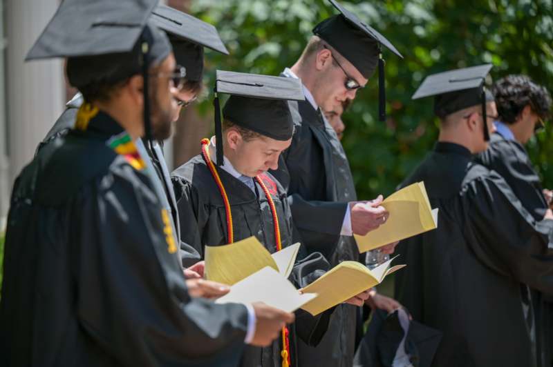 a group of people in graduation gowns and caps