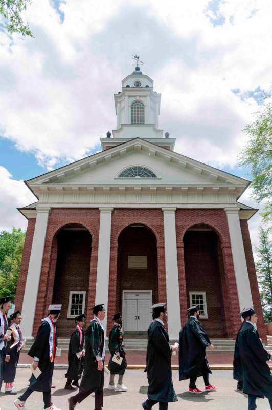 a group of people in uniform standing in front of a building
