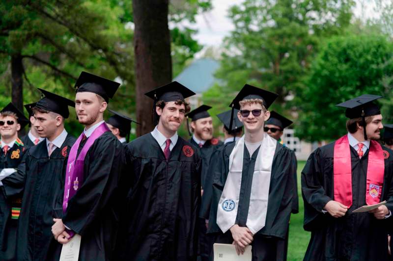 a group of people in graduation gowns and caps