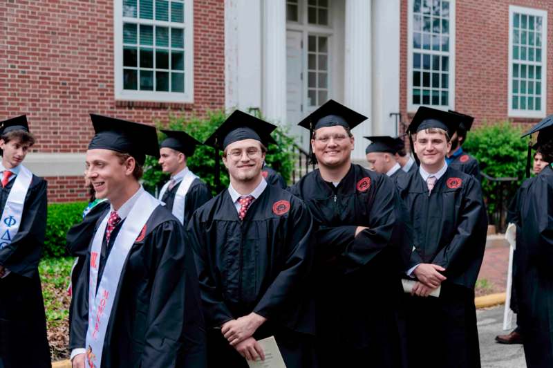 a group of men in graduation gowns