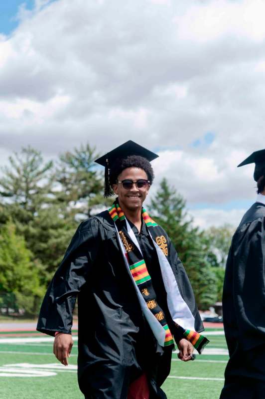 a man in a graduation gown and cap