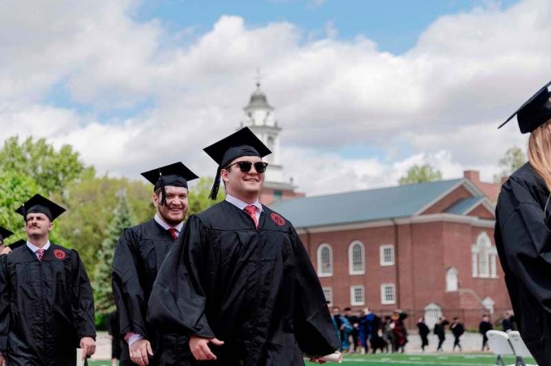 a group of men in graduation gowns and caps