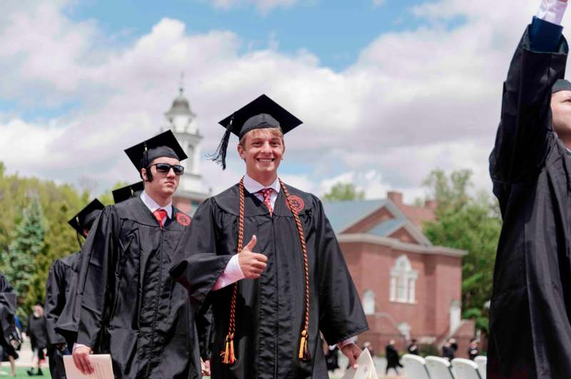 a group of men in graduation gowns
