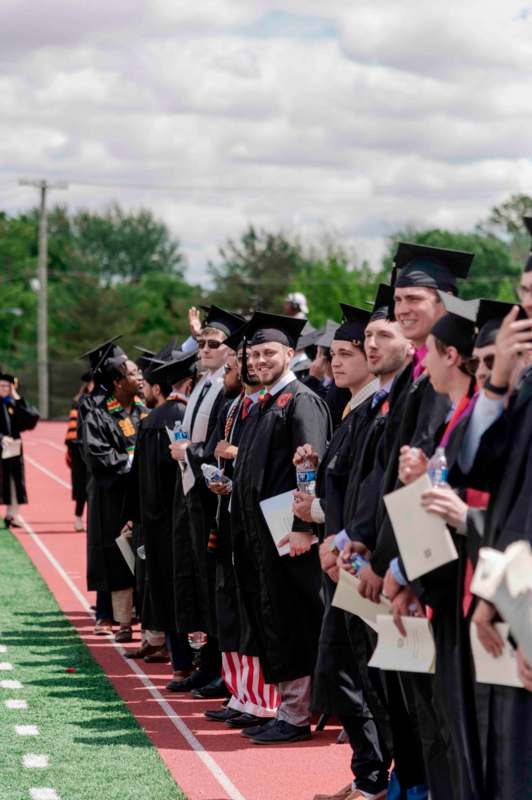 a group of people in graduation gowns and caps