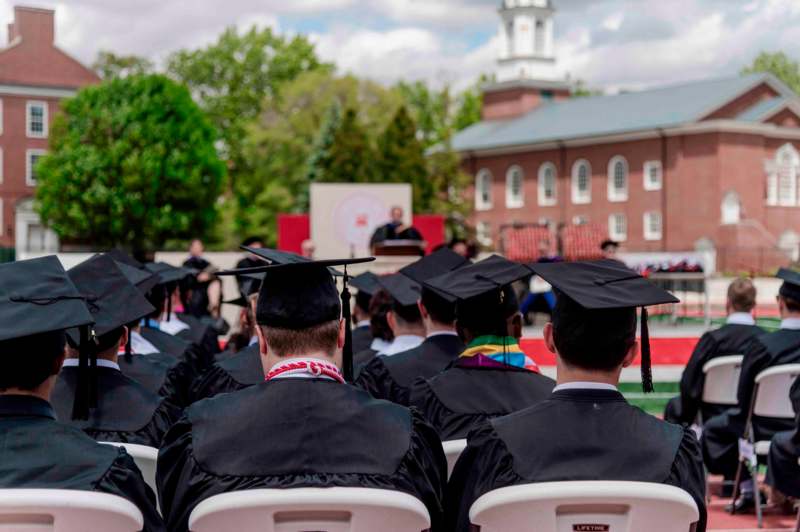 a group of people in graduation gowns and caps