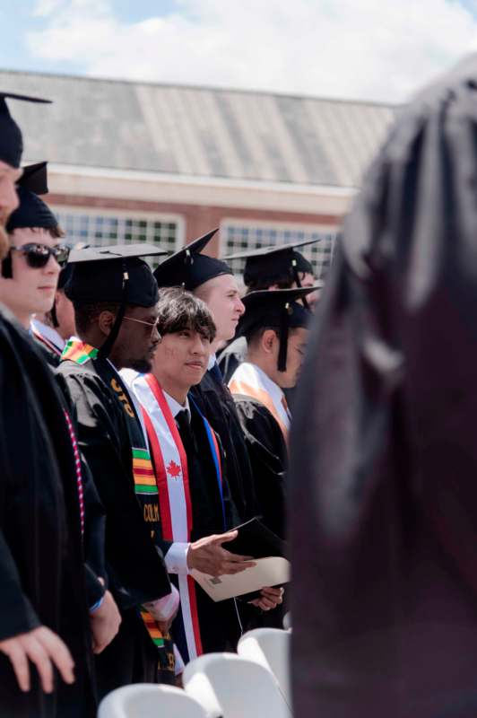a group of people in graduation gowns and caps