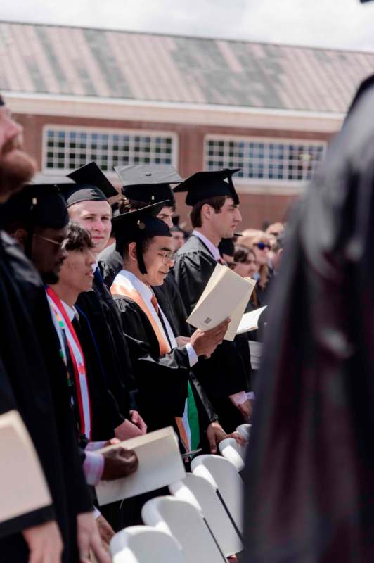 a group of people in graduation gowns and caps