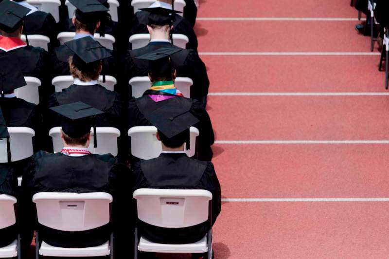 a group of graduates sitting in chairs