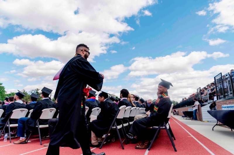 a group of people in graduation gowns and caps