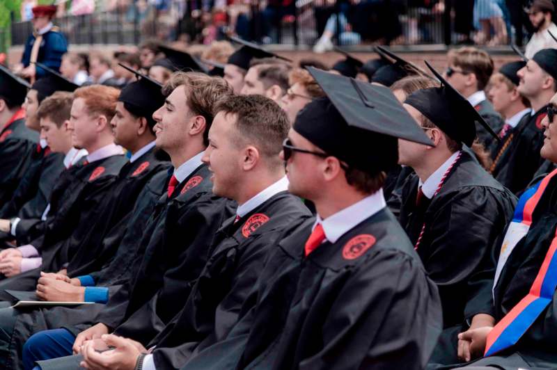 a group of people in graduation gowns and caps