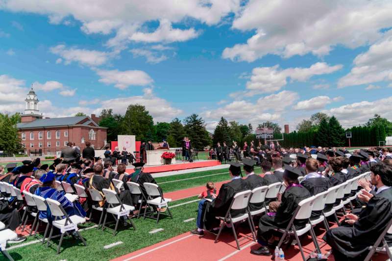 a group of people sitting in chairs on a track