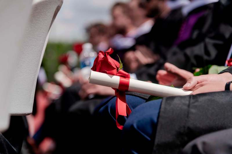 a person holding a diploma