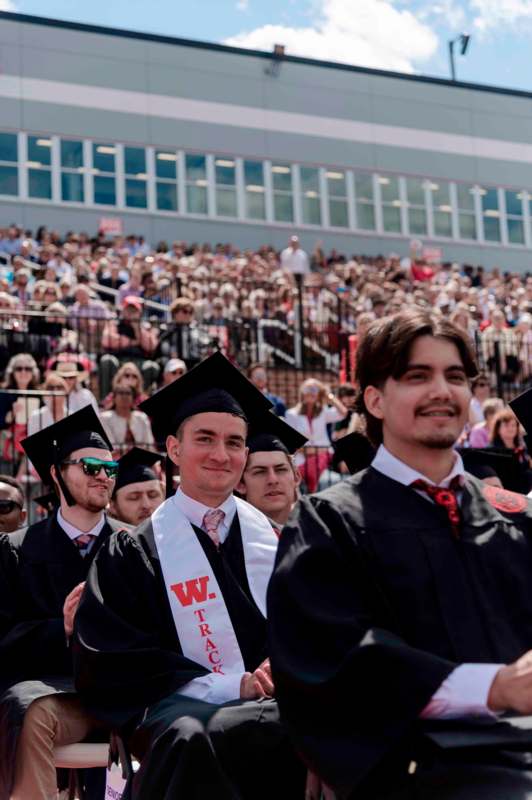 a group of people in graduation gowns and caps