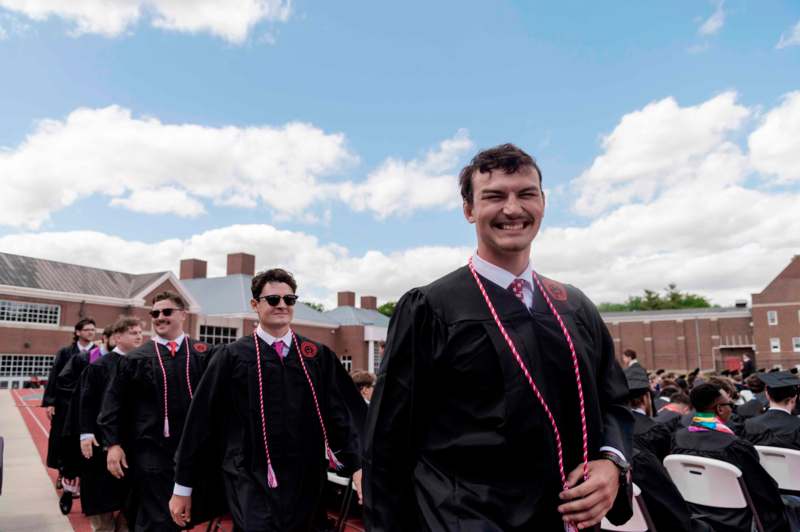 a group of men wearing graduation gowns