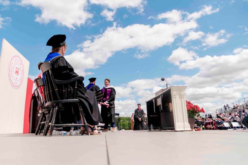 a group of people sitting in chairs outside