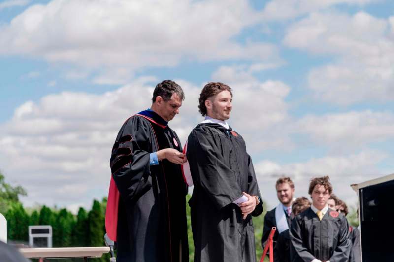 a group of men in graduation gowns