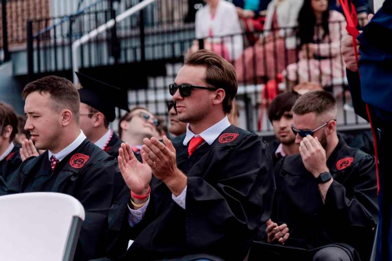 a group of people in graduation gowns and caps