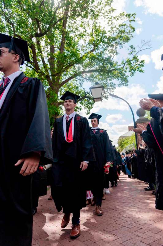 a group of people in graduation gowns and caps