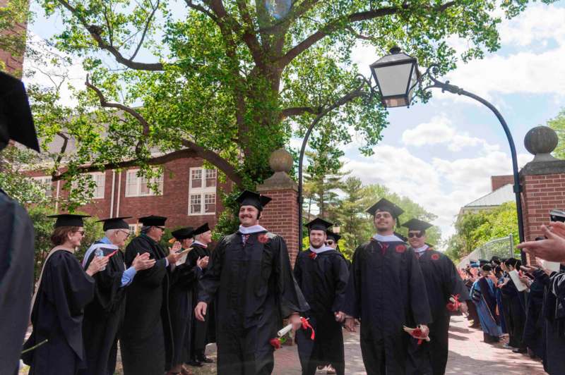 a group of people in graduation gowns and caps