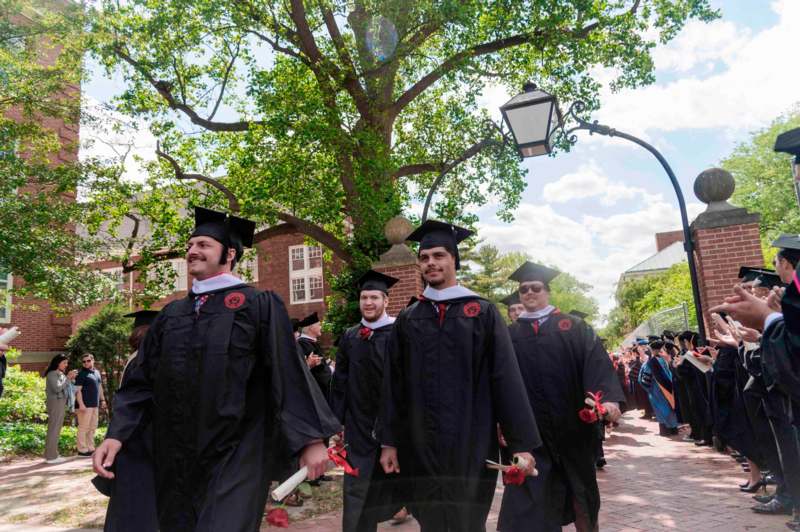 a group of people in graduation gowns and caps