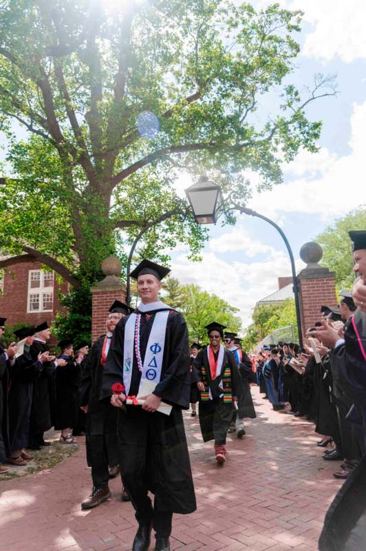 a group of people in graduation gowns and caps