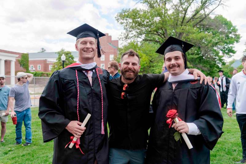 a group of men in graduation gowns and caps