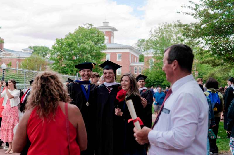 a group of people in graduation gowns and caps