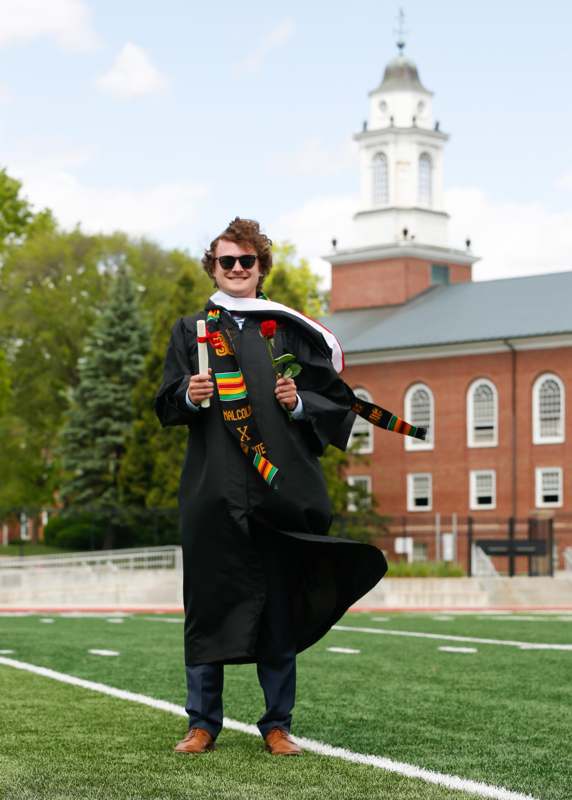 a man in a graduation gown and scarf