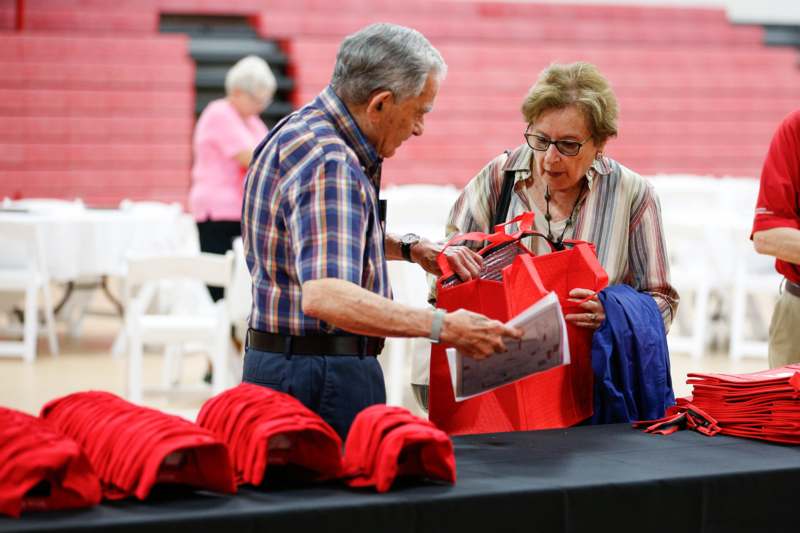 a man and woman looking at a bag