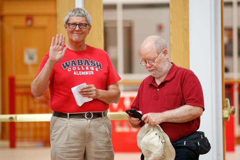 a man waving to another man