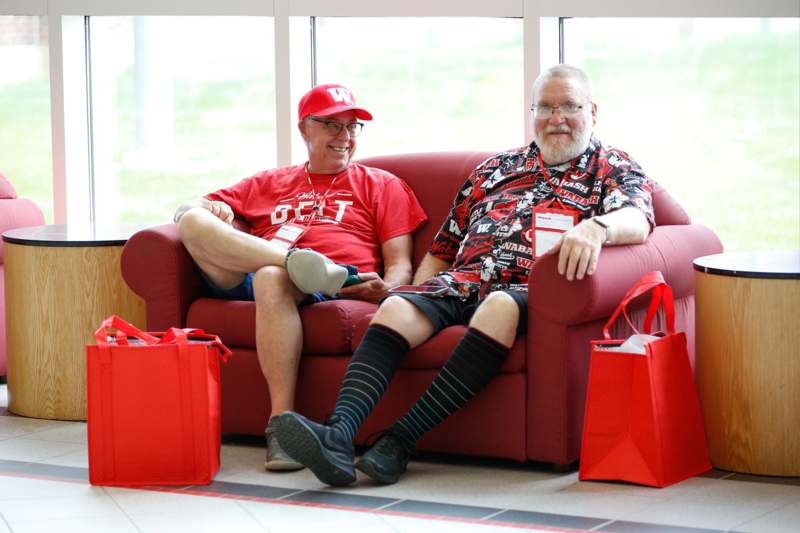 two men sitting on a couch