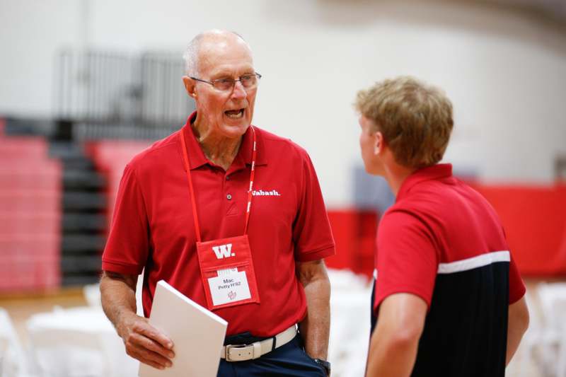 a man talking to a young man