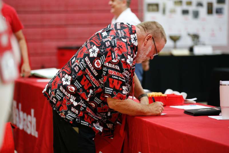a man writing on a table