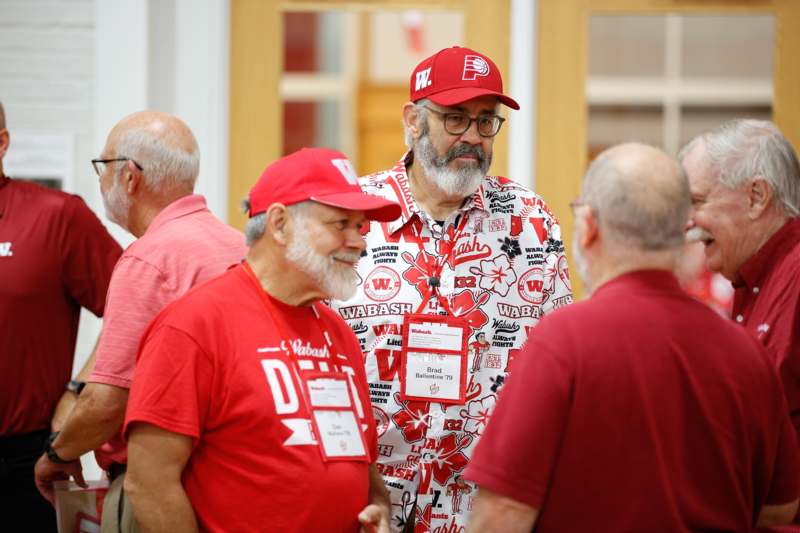 a group of men wearing red shirts and hats