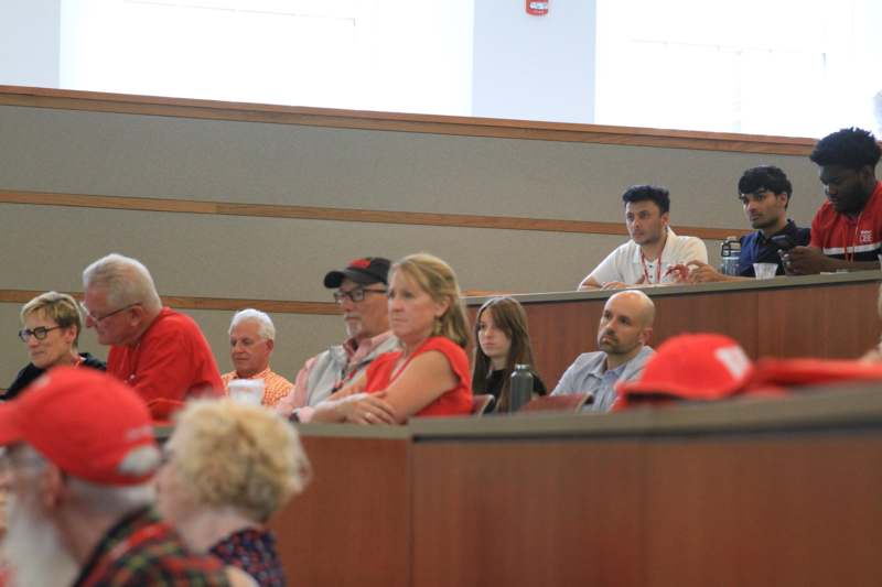 a group of people sitting in a lecture hall