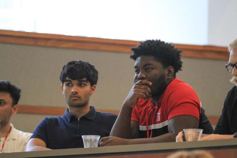 a group of men sitting at a table