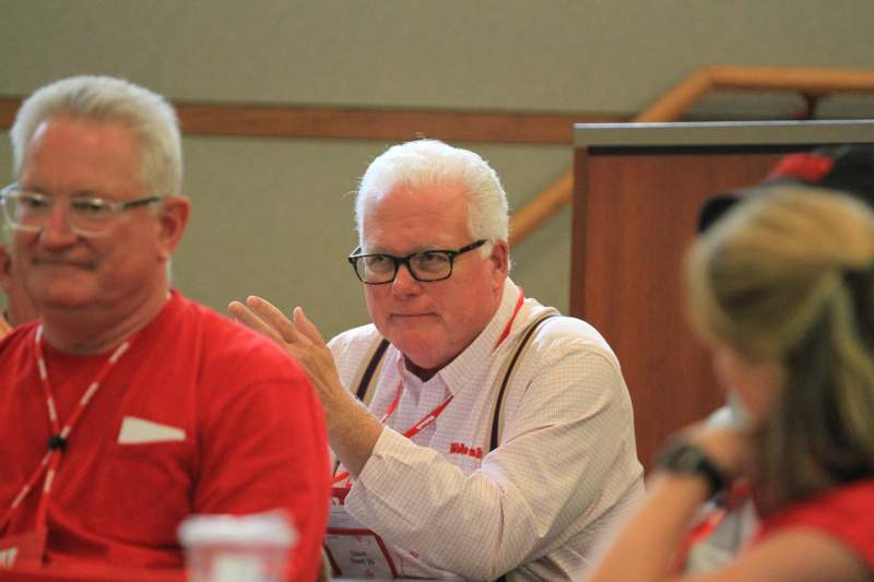 a man sitting at a table with other people