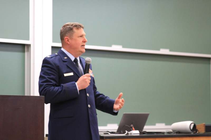 a man in a uniform speaking into a microphone