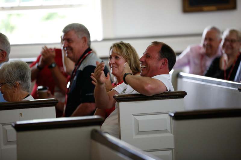 a group of people sitting in pews